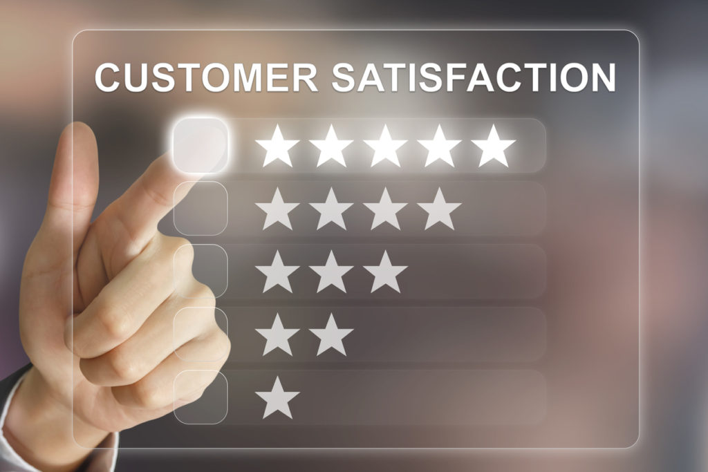 A hand is pointing to the words customer satisfaction.