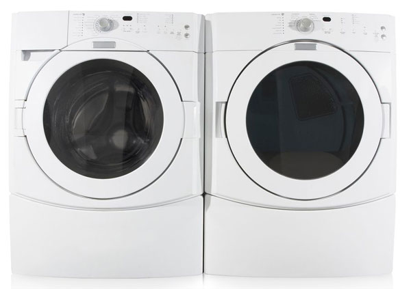 Two white washer and dryer machines side by side.