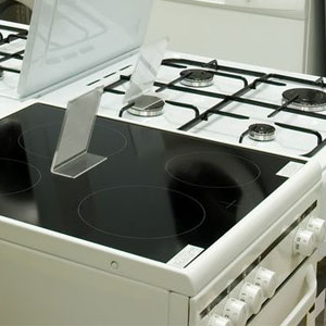A white stove with black top and oven.